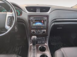 Interior view of 2017 Chevrolet Traverse 2LT AWD dashboard with touchscreen display, gear shifter, and climate controls, showcasing features for family-friendly SUV experience.