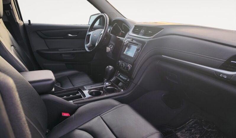 Interior view of a 2017 Chevrolet Traverse 2LT AWD showcasing black leather seating, dashboard controls, and a spacious cabin designed for comfort and family use.