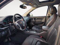 Interior view of a 2017 Chevrolet Traverse 2LT AWD, showcasing black leather seats, dashboard with Chevrolet logo, and spacious cabin design, highlighting comfort and family-friendly features for Calgary's winter conditions.