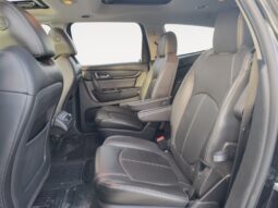 Interior view of 2017 Chevrolet Traverse 2LT AWD showing spacious black leather seating in the second row, designed for family comfort and utility.