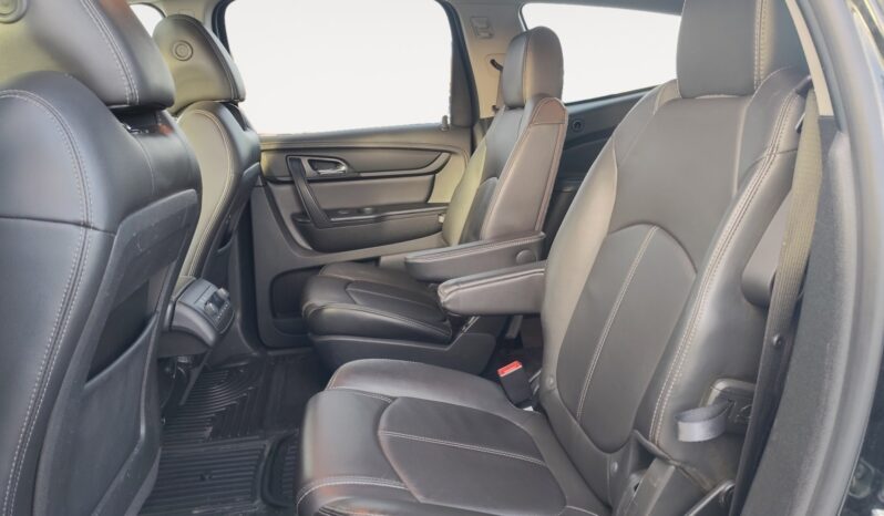 Interior view of 2017 Chevrolet Traverse 2LT AWD showing spacious black leather seating in the second row, designed for family comfort and convenience.