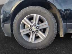 Close-up view of the wheel and tire of a 2017 Chevrolet Traverse 2LT AWD, showcasing the alloy rim design and rugged tread suitable for winter conditions.