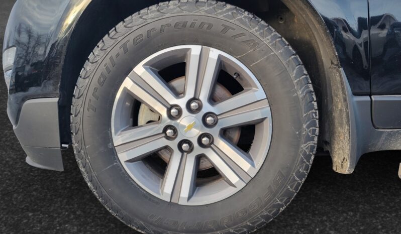 2017 Chevrolet Traverse 2LT AWD front left wheel showcasing alloy rim and all-terrain tire, highlighting suitability for Calgary's winter conditions.