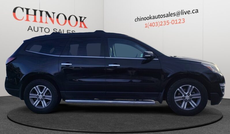 2017 Chevrolet Traverse 2LT AWD in black, side view, showcasing SUV design and features, displayed at Chinook Auto Sales.