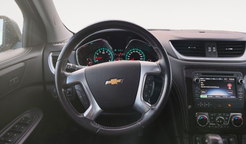 Chevrolet Traverse 2LT AWD interior view featuring steering wheel, dashboard, and infotainment system, highlighting features relevant for Calgary families.