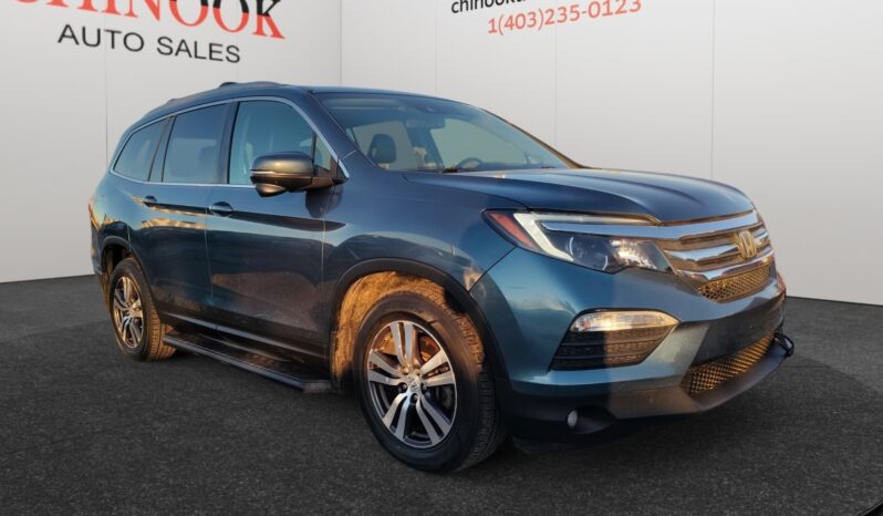 2016 Honda Pilot EXL-R SUV in blue, showcasing a front-right view with a modern design, parked at Chinook Auto Sales, emphasizing family-friendly features and 4-wheel drive capability.