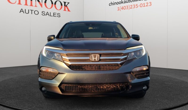 2016 Honda Pilot EXL-R SUV in blue, showcasing front view with distinctive grille and headlights, displayed at Chinook Auto Sales dealership.
