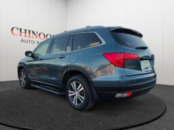 2015 Ford Escape SE in blue, rear-left view, displayed at Chinook Auto Sales, highlighting its used condition and SUV body style.