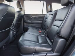 Interior view of the rear seating area in a 2016 Honda Pilot EXL-R, featuring black leather upholstery, spacious seating for up to three passengers, and a clean, modern design suitable for families.