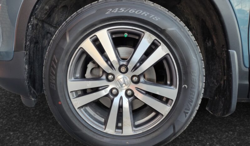 Honda Pilot EXL-R front left wheel showcasing alloy rim and tire specifications 245/60R18, relevant to the 2016 SUV listing at Chinook Auto Sales.
