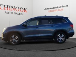 2016 Honda Pilot EXL-R SUV in blue, showcasing side profile, displayed at Chinook Auto Sales for sale, highlighting spacious design and family-friendly features.