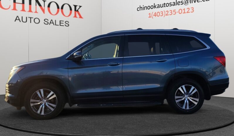 2016 Honda Pilot EXL-R SUV in blue, showcasing side profile with dealership branding, ideal for families and 4WD capability.
