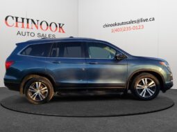 2016 Honda Pilot EXL-R SUV in blue, side view with Chinook Auto Sales branding, showcasing spacious design and premium features for family comfort.