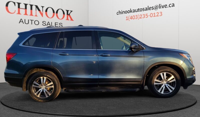 2016 Honda Pilot EXL-R SUV in blue, showcasing a side view with sleek lines and alloy wheels, displayed at Chinook Auto Sales for CAD $23,998, emphasizing family-friendly features and 4WD capability.