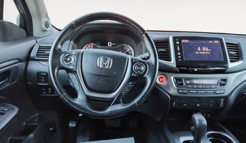 Honda Pilot EXL-R interior featuring steering wheel, dashboard display, and control panel, showcasing modern design and technology for a 2016 SUV.